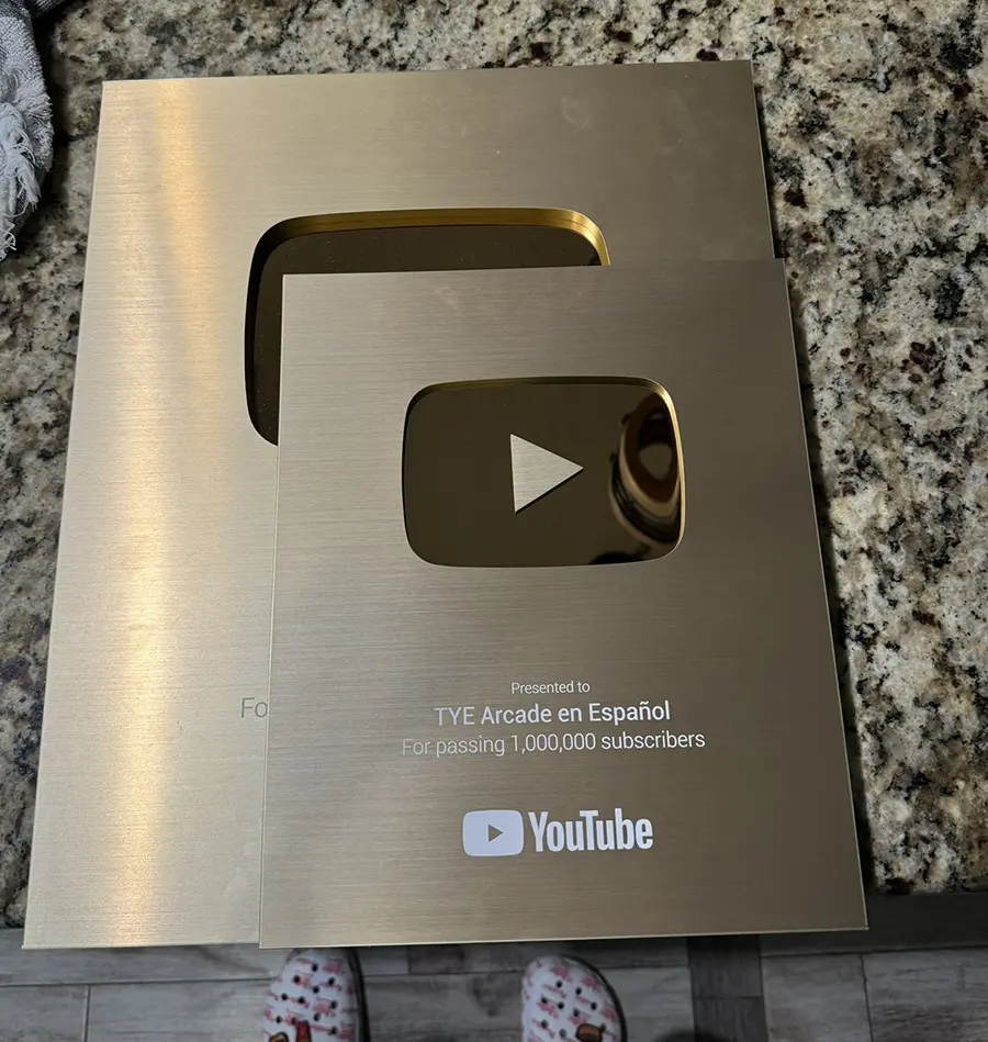 Detailed side-by-side comparison of the 2018 legacy Silver play button versus the 2024 redesigned smaller version